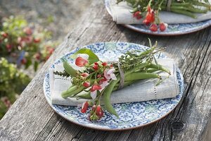 Napkin decoration with vegetables and herbs, beans and flowers