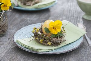 Easter table decoration with horned violets