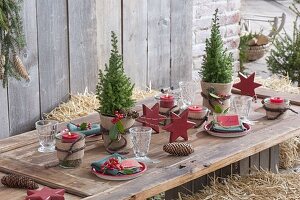 Christmas table decoration with straw bales on the terrace
