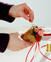 Homemade tree ornament: Filled coconut bag as tree ornament. Wire