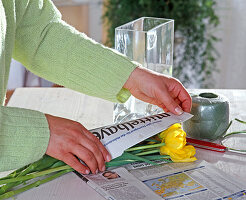 Wrapping crooked tulips in newspaper