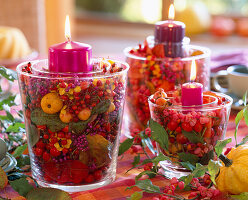 Candle glasses with berry decorations