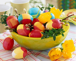 Bowl with coloured eggs (3/3). Buxus (box branch), Salix (catkin willow), Tulipa