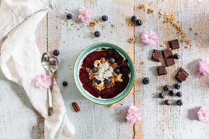 A smoothie bowl with berries and nuts