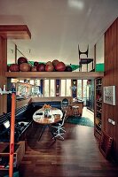 Dining room with corner bench and collection of medicine balls on the shelf