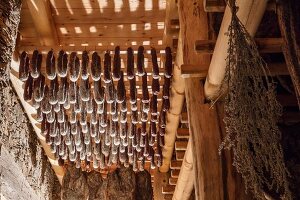 Bacon and sausages in the curing chamber at the Hofmanufaktur Kral in South Tyrol