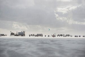 Beach huts and kite surfers on the beach of St. Peter-Ording, North Sea, Schleswig-Holstein