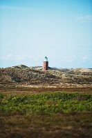 Lighthouse between the dunes in Schleswig-Holstein