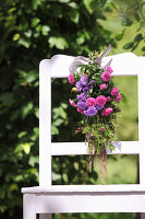 Posy of asters on back of chair