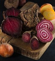 Red, yellow and striped beetroot on a wooden board