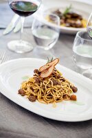 Noodles with bacon ragout and dried pear slices