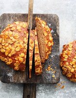 A loaf of wheat bread with dried apples and cornflakes