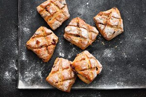 Muesli bread rolls on a baking tray