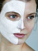 Portrait of a woman with a face mask on half of her face