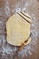 Rolled-out pastry on a wooden board