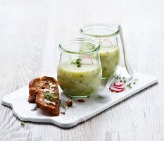 Herb and potato soup in glasses