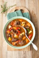 Fiery goulash soup with peppers and mushrooms