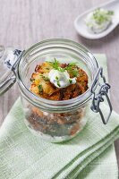 Baked aubergines with tzatziki in a glass jar