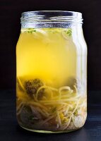 Chicken soup with liver dumplings and egg noodles in a glass jar