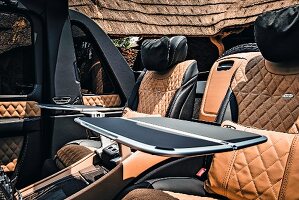 Backseats with tables in the Mercedes-Maybach G 650, an SUV by Mercedes, on safari in Africa
