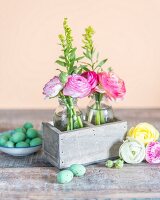 Rustic Easter arrangement of delicate ranunculus