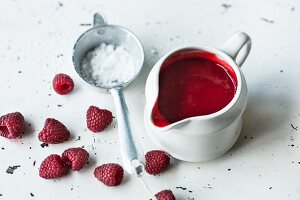 Raspberry coulis with icing sugar