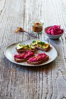 Open sandwiches with avocado and beetroot hummus
