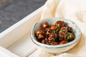 Fried mushrooms cooked with Italian herbs in a ceramic bowl
