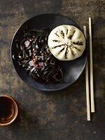 An Asian bao bun and squid ink noodles (Asia)
