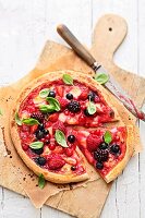 A berry pizza with mozzarella