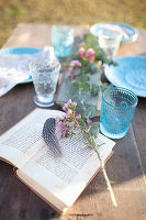 Open book on set table outside