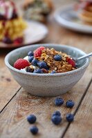 Homemade granola with fresh berries and yoghurt