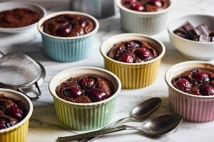 Chocolate and cherry clafoutis in colourful ramekins