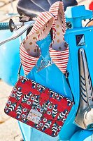 Red and white striped shoes and a leather shoulder bag