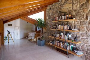 Steel and wooden shelves against stone wall