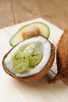 Avocado and coconut ice cream served in a coconut half