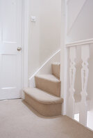 Staircase with newly laid beige carpet