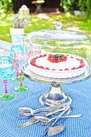 Summery berry cake on a garden table