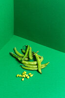 Broad beans on green background