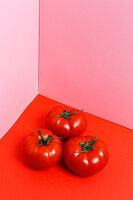 Red tomatoes on a red surface