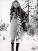 A young woman in the snow wearing a tutu dress and a parka (black-and-white shot)