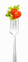 Lettuce, tomato and radish on a fork
