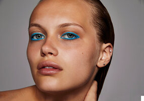 A woman wearing blue eye make-up