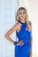 A blonde woman wearing a blue dress