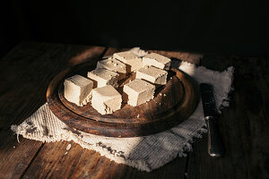 Diced halva on a wooden plate