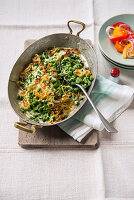 Cheese egg pasta with stinging nettles and red onions