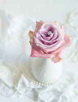 Romantic wedding decoration: ring nestled in a rose