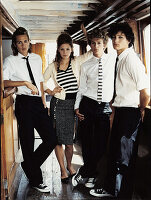 Four young people wearing black-and-white outfits at a bar