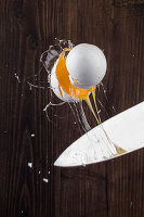 An egg cracked with a knife