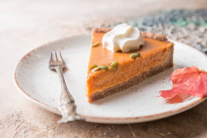 Slice of Festive Homemade Pumpkin Pie with Whipped Cream